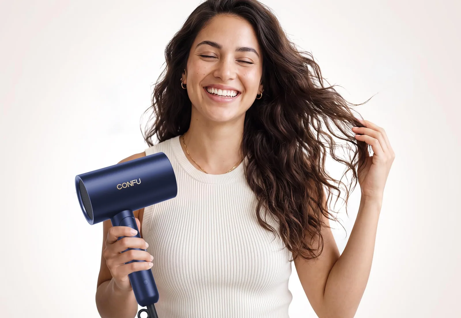 A woman with long curls holding the blue CONFU foldable diffuser dryer