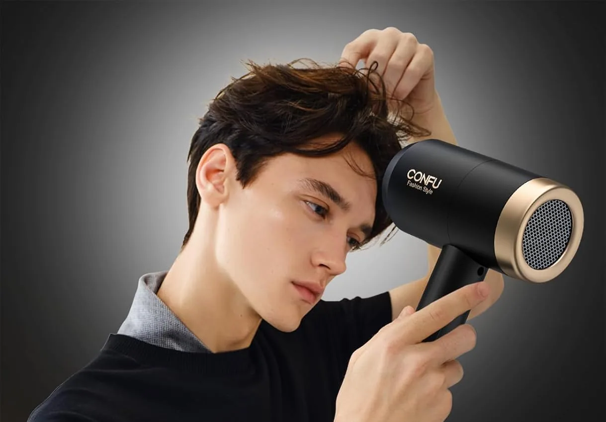 A man drying his hair with the black CONFU 1600W ionic dryer